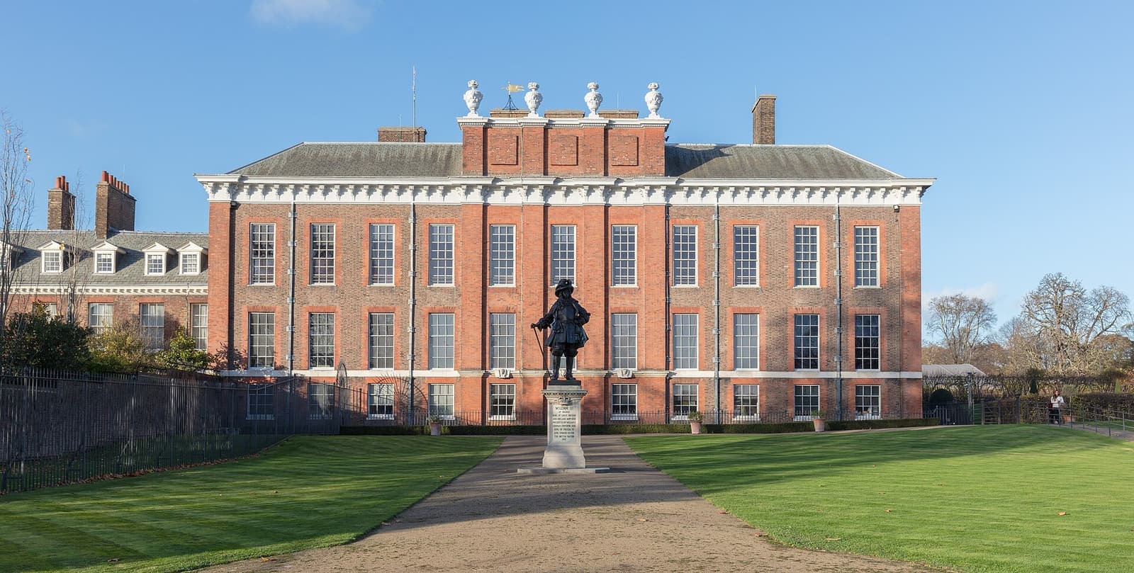 The red-brick south front of Kensington Palace with the statue of William III