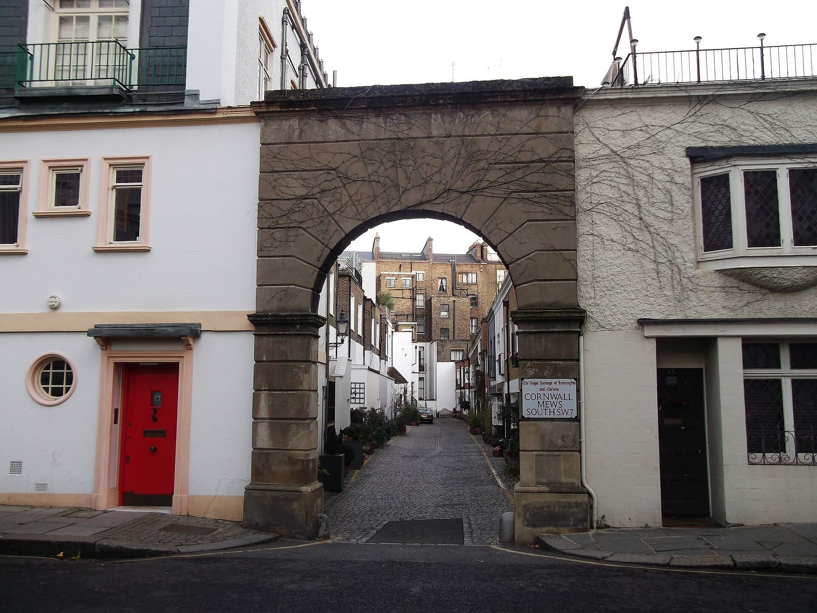 The arched entrance to a cobbled mews in South Kensington